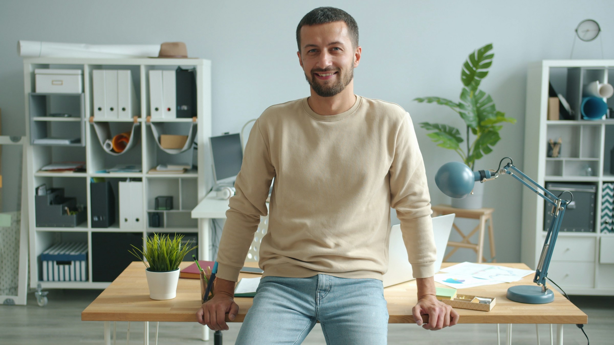 Startup founder-style professional headshot in a modern office workspace
